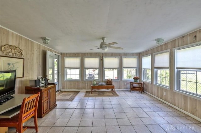 sunroom / solarium featuring ceiling fan