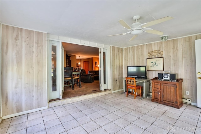 home office with light tile patterned floors, wooden walls, ceiling fan, and baseboard heating