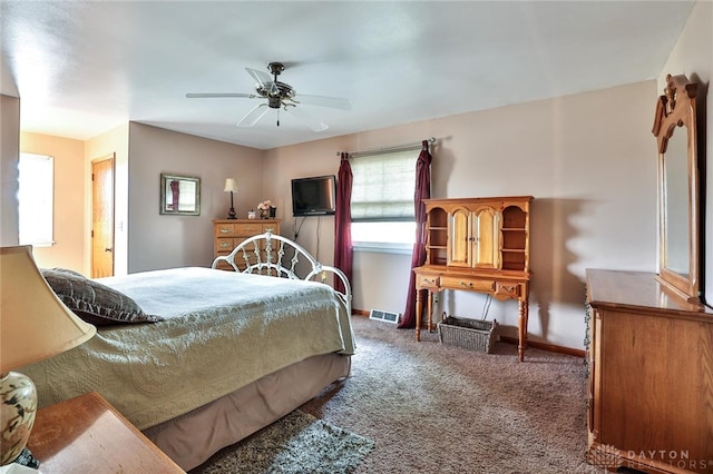 bedroom featuring dark carpet and ceiling fan