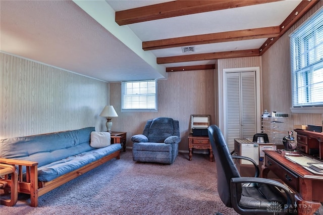 carpeted home office with beamed ceiling