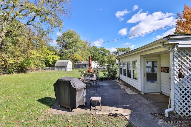 view of yard featuring a patio and a storage shed