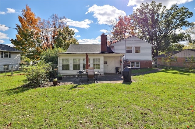 back of property featuring a patio and a lawn