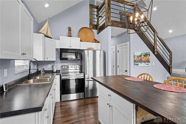 kitchen with white cabinetry, sink, dark hardwood / wood-style floors, a notable chandelier, and appliances with stainless steel finishes