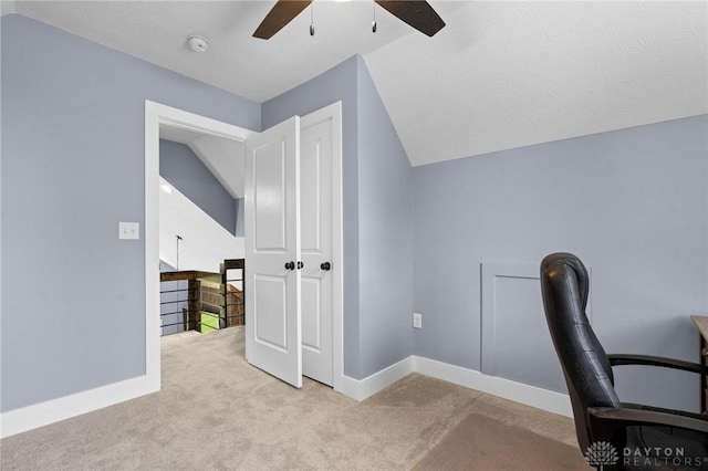 office with lofted ceiling, carpet floors, a ceiling fan, and baseboards