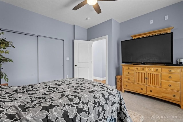 carpeted bedroom with a closet and a ceiling fan