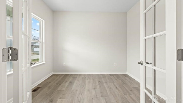 unfurnished room with light wood-type flooring