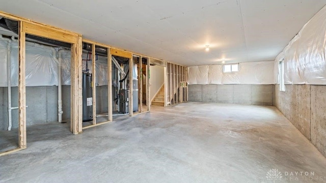 basement featuring heating unit and water heater