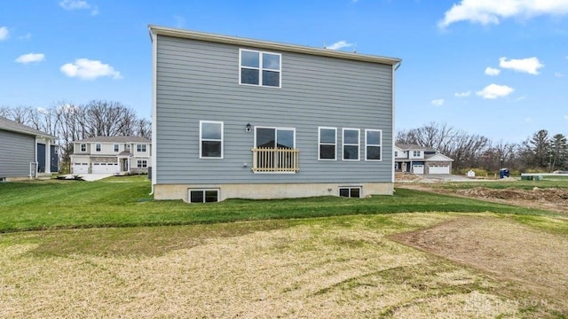 back of property featuring a lawn