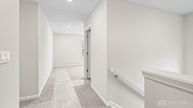 hallway with light colored carpet