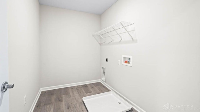 laundry room with electric dryer hookup, hookup for a washing machine, and hardwood / wood-style flooring