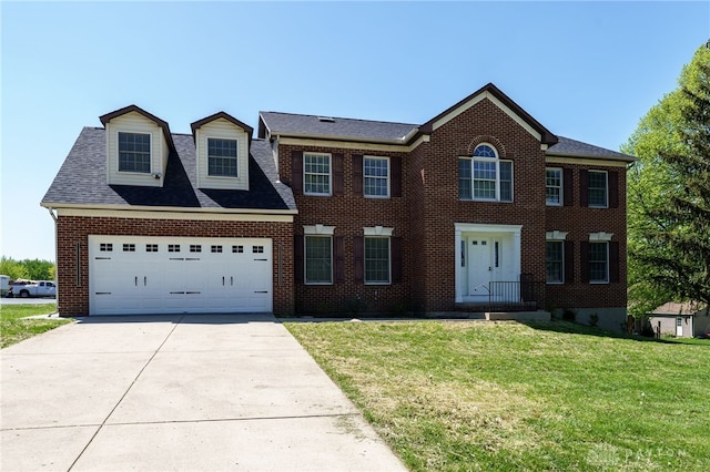 colonial inspired home with a front lawn and a garage