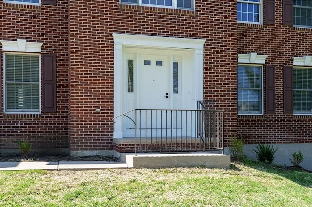 doorway to property with a lawn