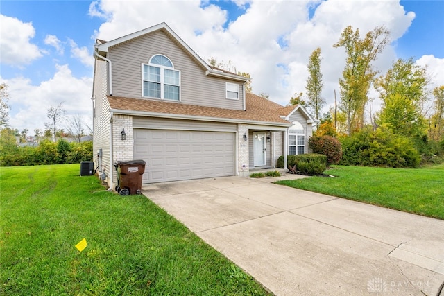 front of property with a front yard, cooling unit, and a garage