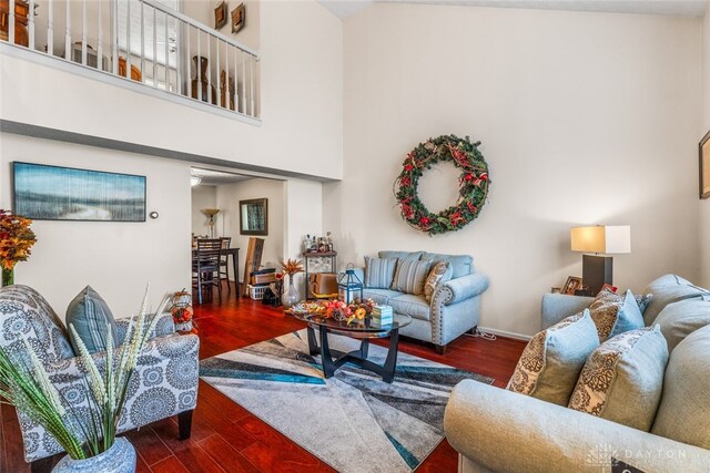 living room featuring dark hardwood / wood-style flooring and a high ceiling