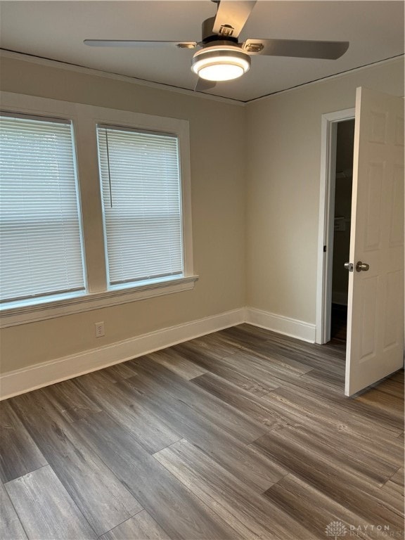 spare room with ceiling fan, wood-type flooring, and ornamental molding