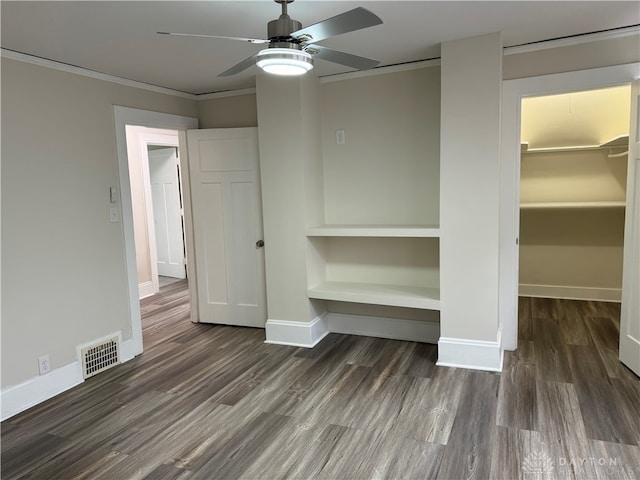 unfurnished bedroom with ceiling fan, crown molding, and dark hardwood / wood-style flooring