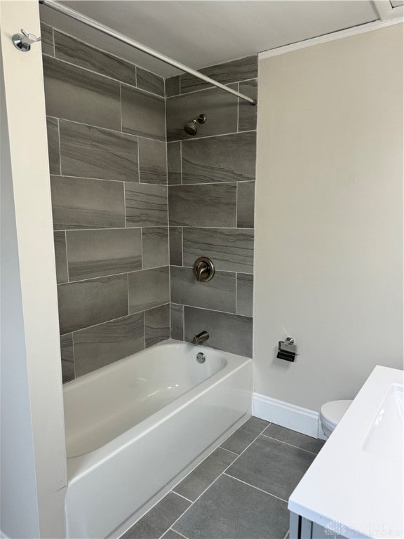 full bathroom with toilet, tiled shower / bath combo, vanity, and tile patterned flooring