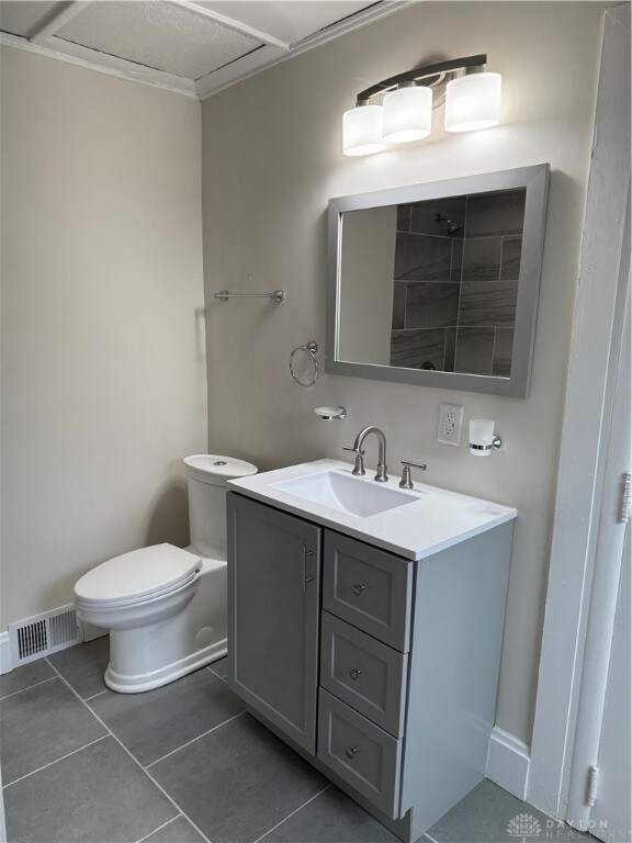 bathroom with vanity, toilet, and tile patterned flooring