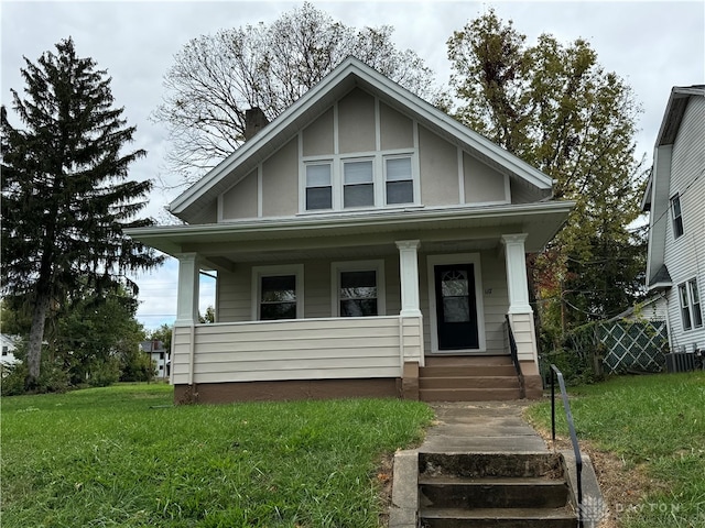 view of front of property with a porch and a front lawn