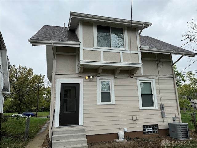 rear view of property featuring central AC unit