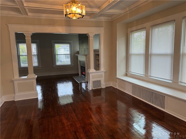 unfurnished living room with beam ceiling, coffered ceiling, a chandelier, and dark hardwood / wood-style floors