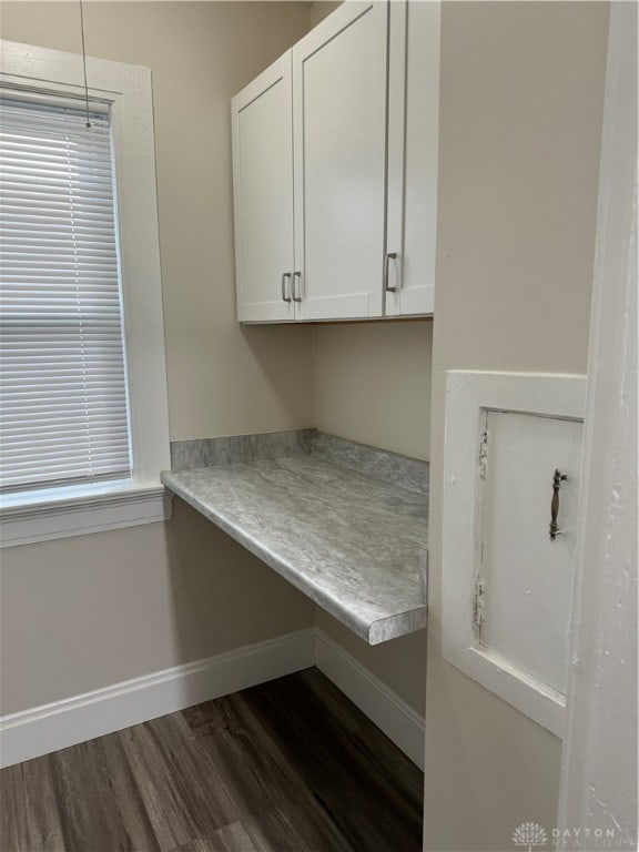 clothes washing area with dark hardwood / wood-style floors