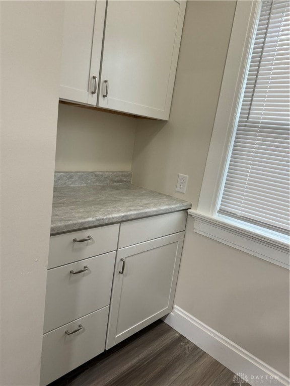 interior space featuring white cabinets and dark hardwood / wood-style floors