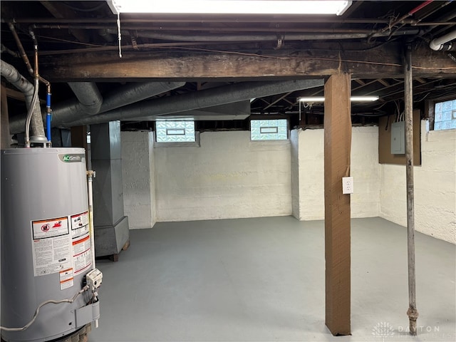 basement featuring heating unit, electric panel, and gas water heater