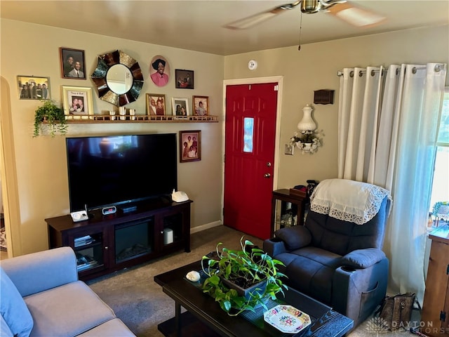 living room with ceiling fan and carpet floors