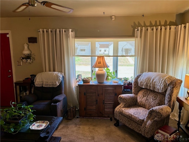 sitting room featuring carpet and ceiling fan