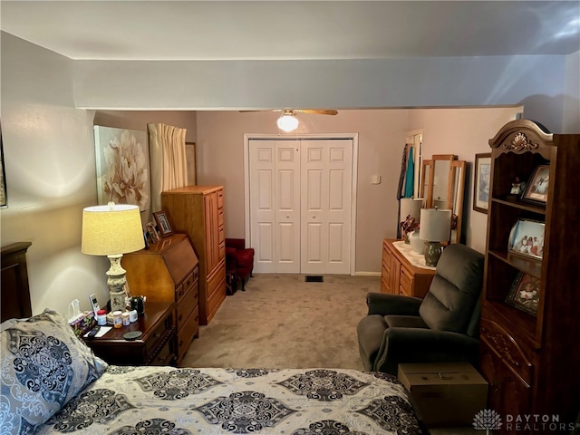 bedroom with light colored carpet and a closet