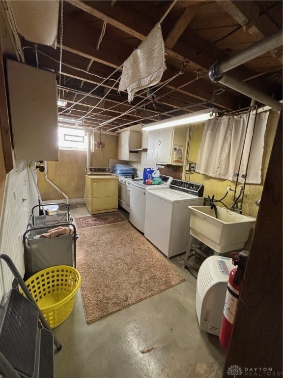 basement with sink and independent washer and dryer