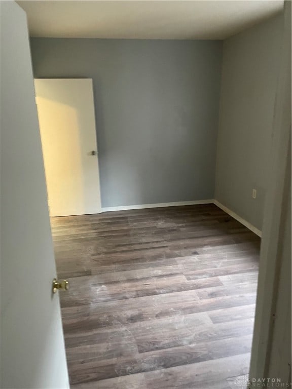 empty room with hardwood / wood-style flooring