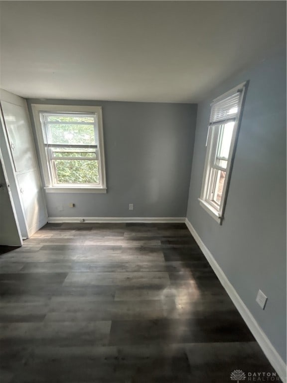 unfurnished room featuring dark hardwood / wood-style flooring