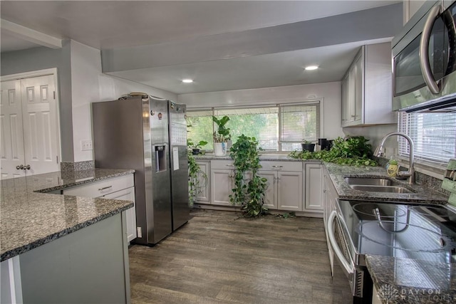 kitchen featuring white cabinets, plenty of natural light, dark wood-type flooring, and appliances with stainless steel finishes