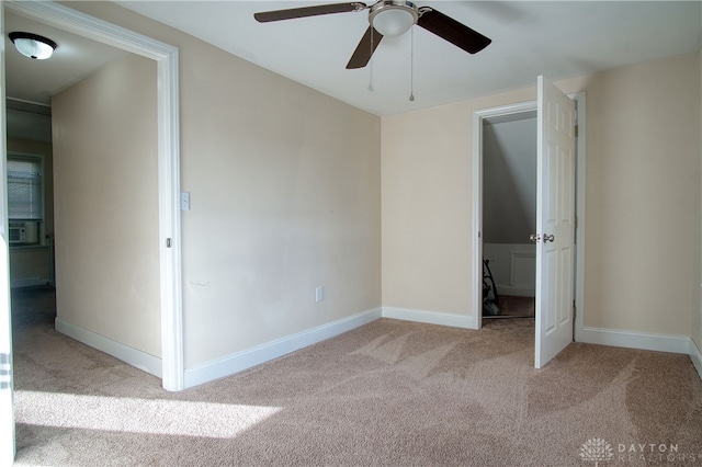 unfurnished bedroom with light carpet, ceiling fan, and cooling unit