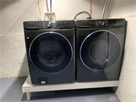 laundry area with washing machine and dryer