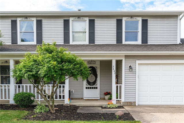 multi unit property with a porch and a garage