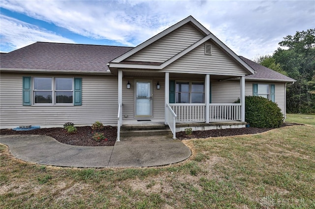 view of front of home with covered porch and a front yard