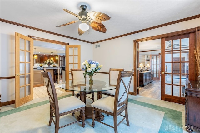 dining room featuring french doors, ceiling fan, crown molding, and a textured ceiling