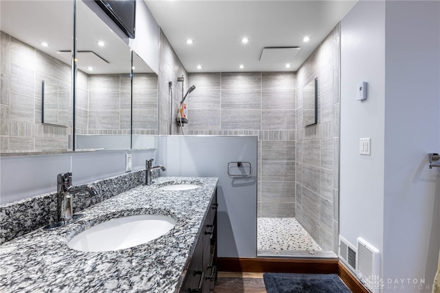 bathroom featuring vanity and a tile shower