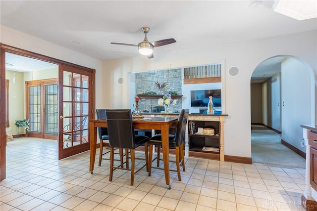 tiled dining area with ceiling fan