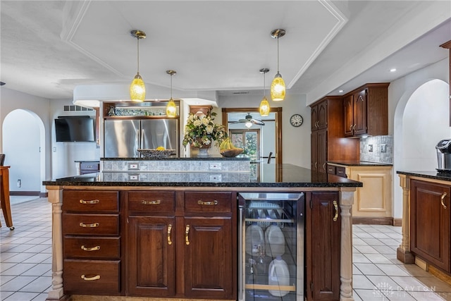 kitchen featuring wine cooler, light tile patterned floors, stainless steel fridge, and tasteful backsplash