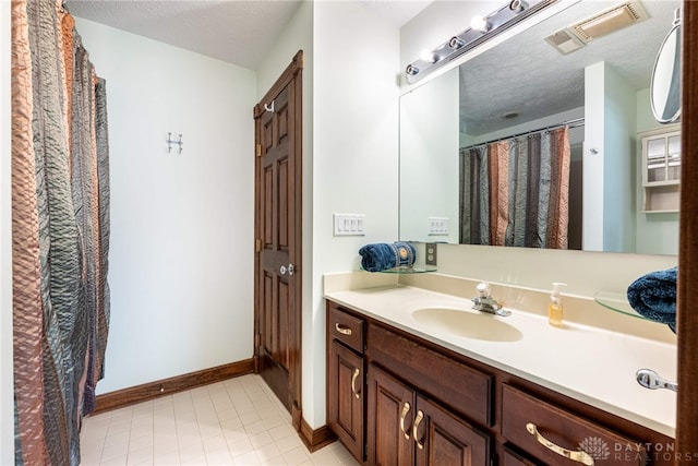 bathroom featuring vanity and a textured ceiling