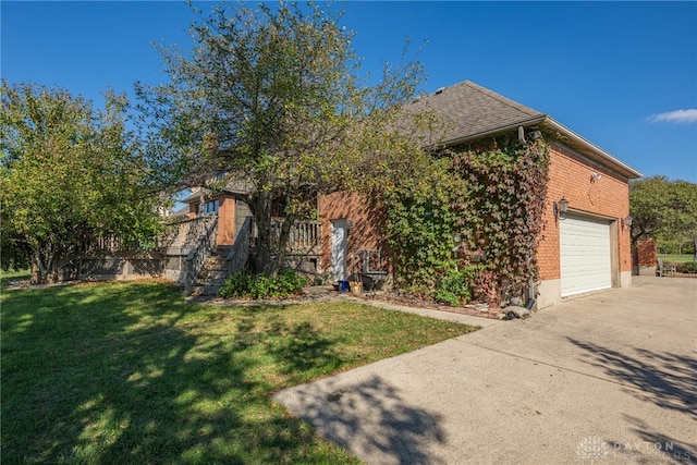 view of front of home featuring a garage and a front lawn