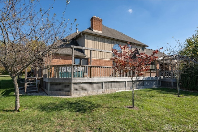 rear view of property with a gazebo, a deck, and a lawn