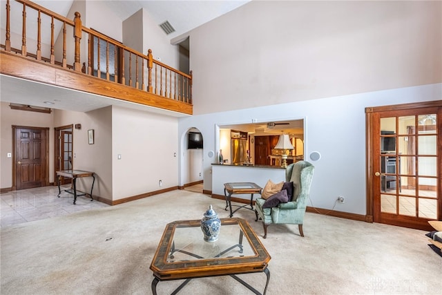 carpeted living room featuring high vaulted ceiling