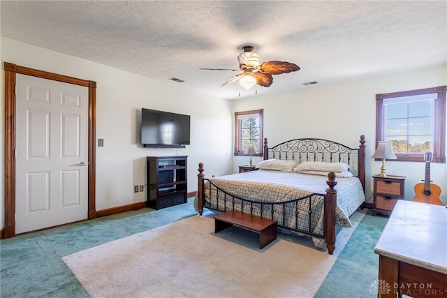 bedroom featuring multiple windows, light colored carpet, and ceiling fan