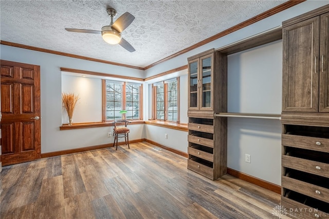 interior space featuring hardwood / wood-style floors, crown molding, a textured ceiling, and ceiling fan