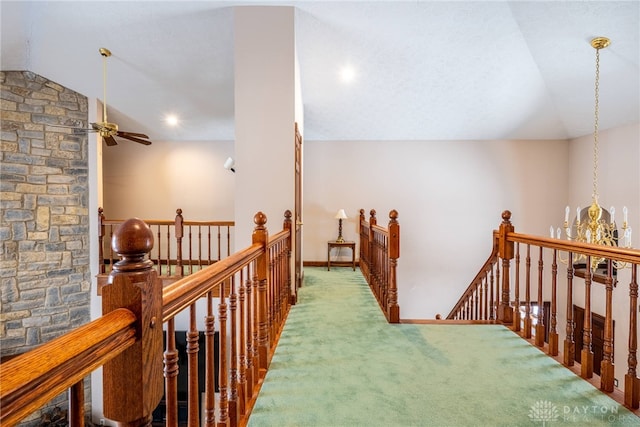 corridor featuring vaulted ceiling and carpet flooring